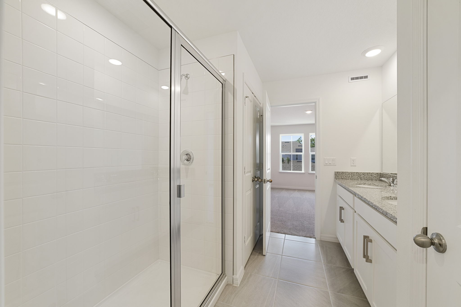 Dual sink vanity with a large mirror and shower