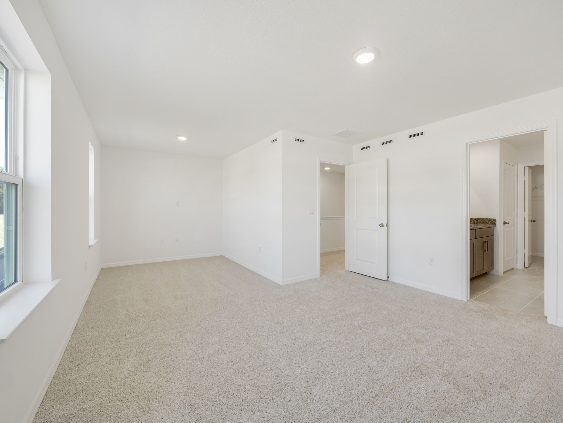 primary bedroom with carpet and sitting area