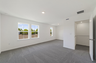 carpet throughout with a sitting room with large windows 