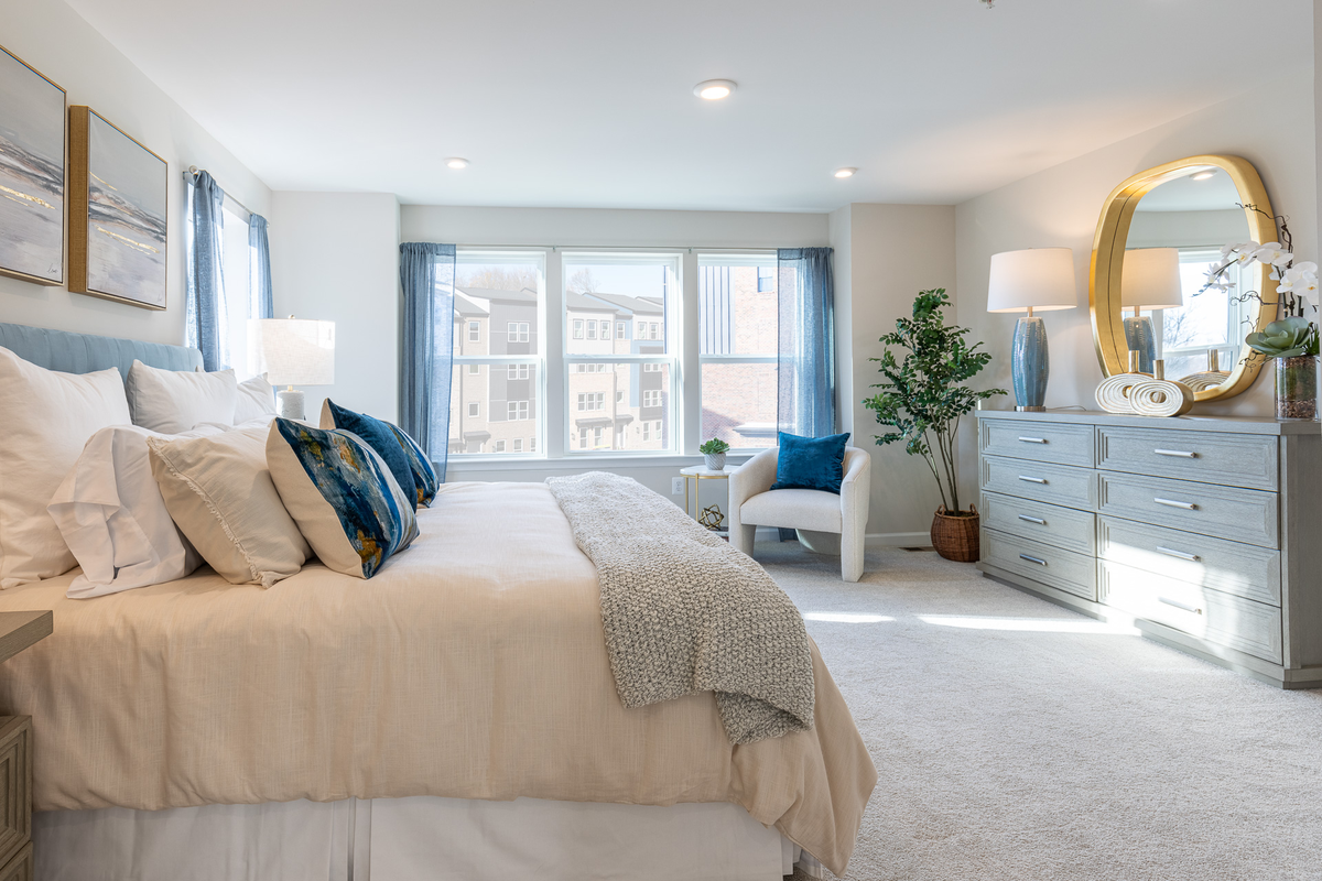 primary suite with a king sized bed and dresser