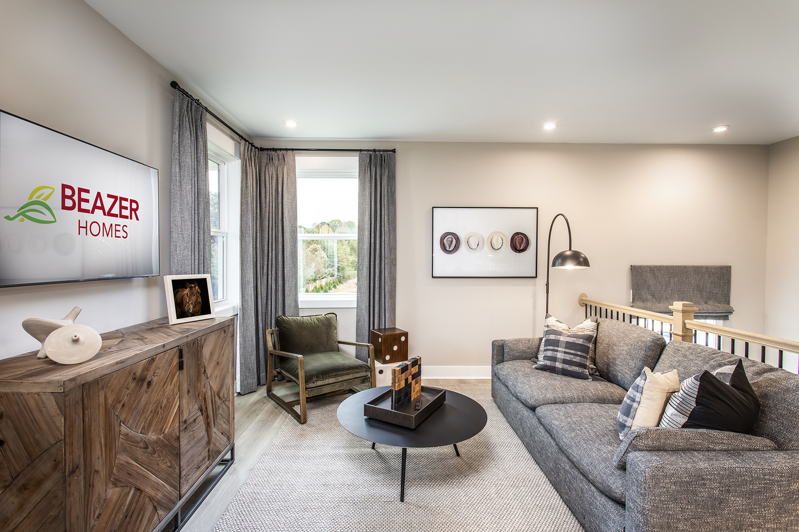 loft with plank flooring and gray couch 