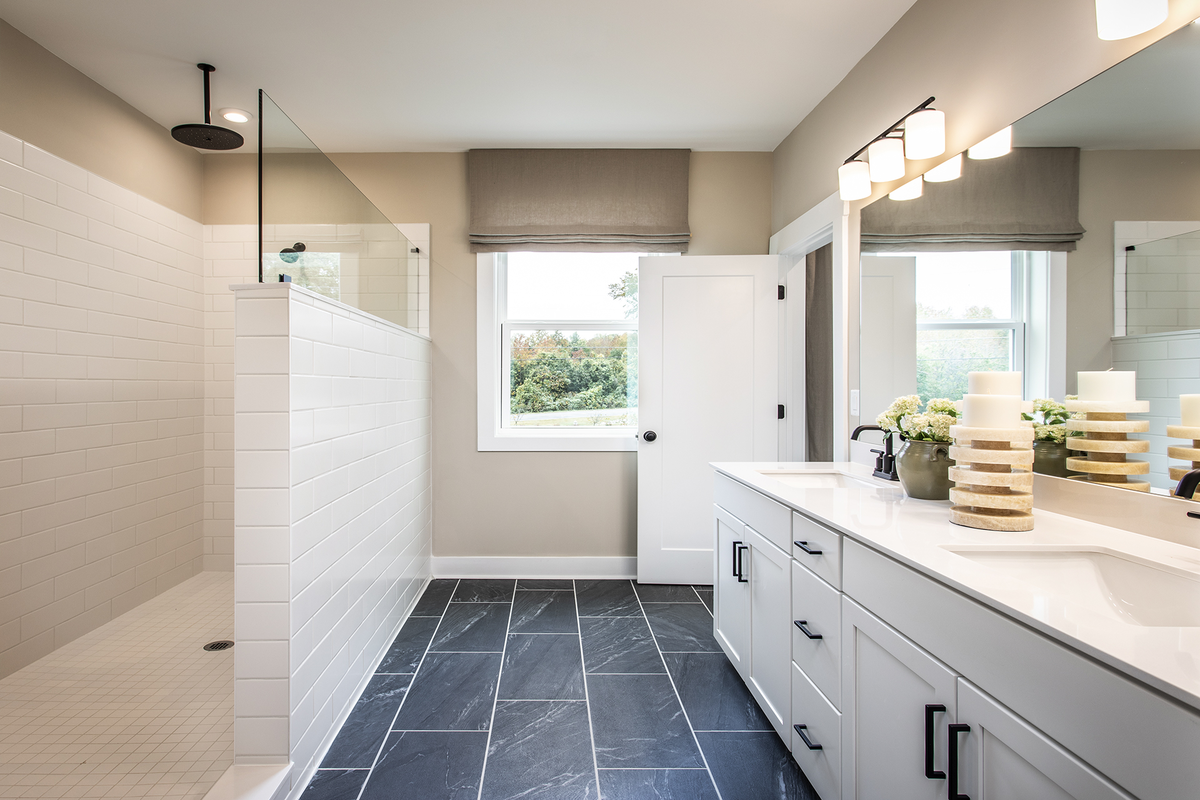 primary bathroom with dual vanity & white cabinets