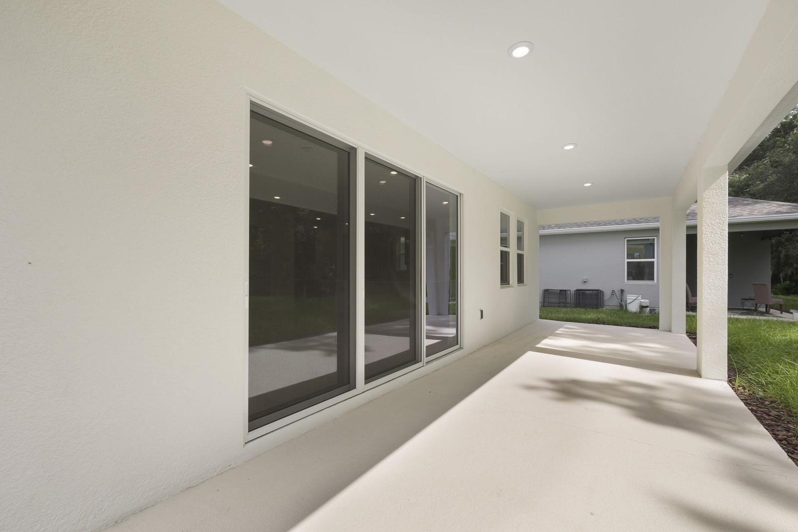 covered patio and backyard