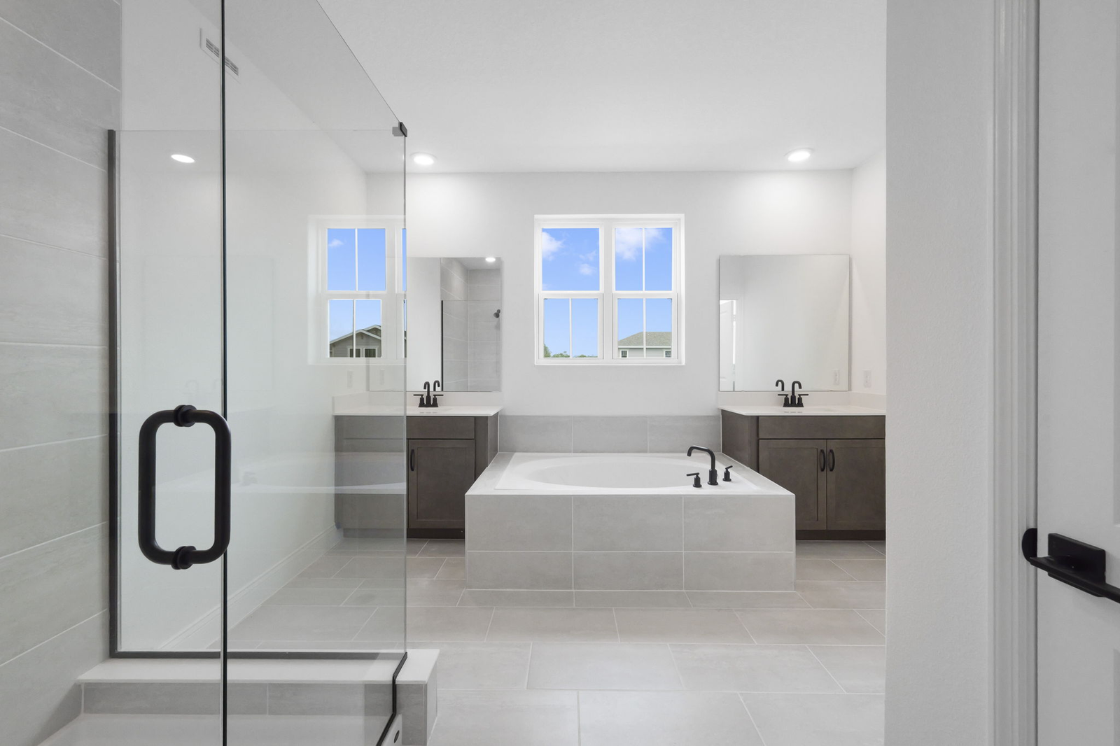 dual sink vanity with an oversized tub and walk in shower