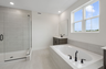 dual sink vanity with an oversized tub and walk in shower