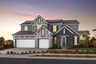 front exterior of two-story gray & white home with three-car garage and solar panels on roof