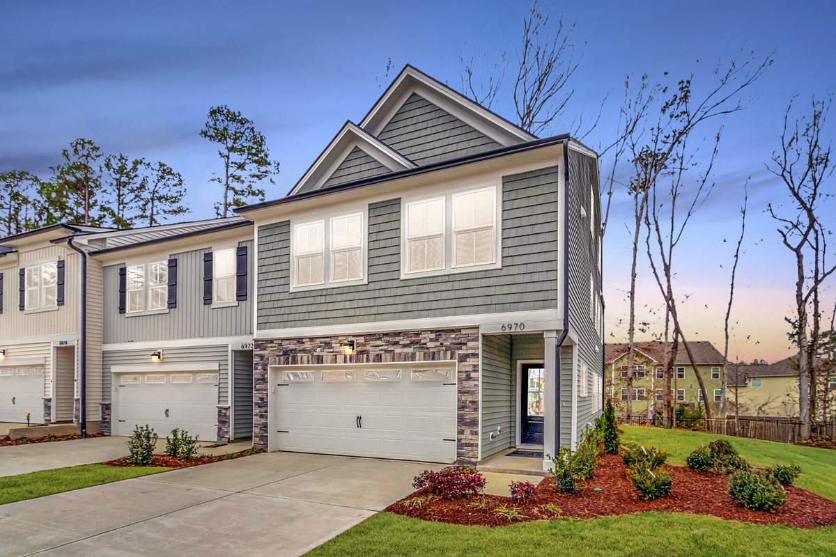 townhome building with stone accents around garage