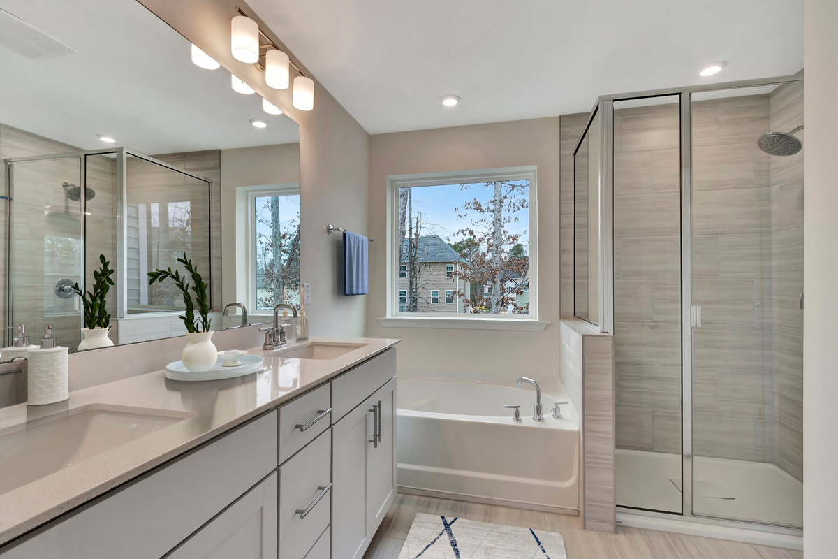 white bathroom with tile shower and soaking tub