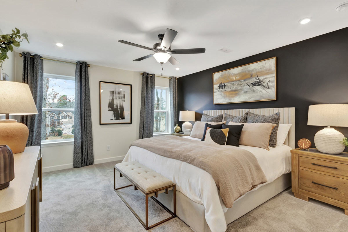 large bedroom with black accent wall and king bed