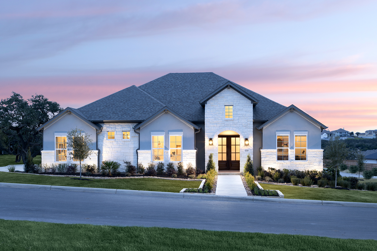 exterior with white stucco, stone & 3-car garage