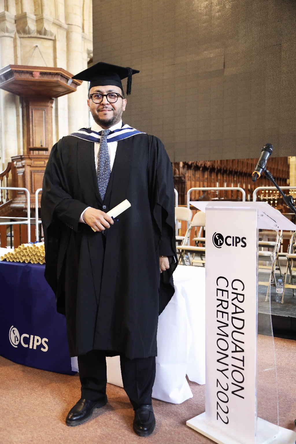 Smiling man holding diploma
