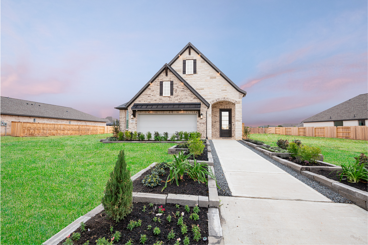 two-story home with stone, brick and dark trim