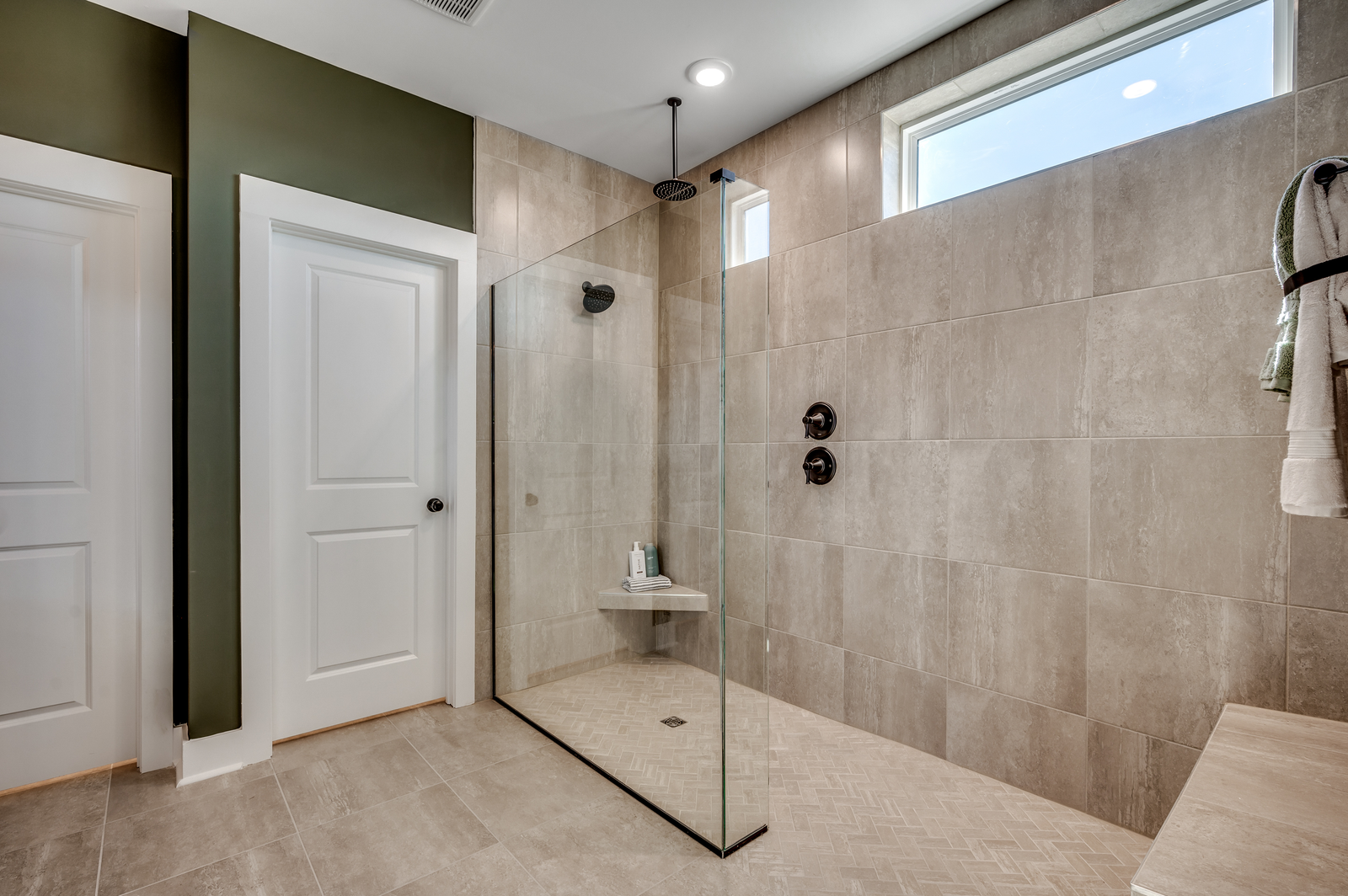 large, tiled walk in shower with glass door
