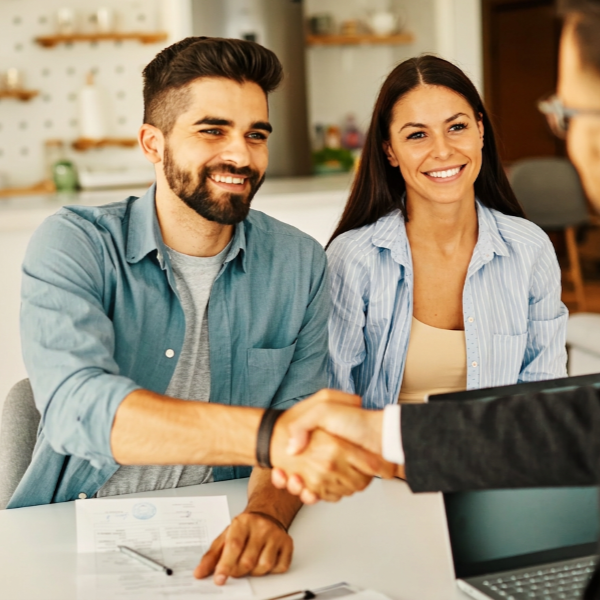 happy couple with the loan officer