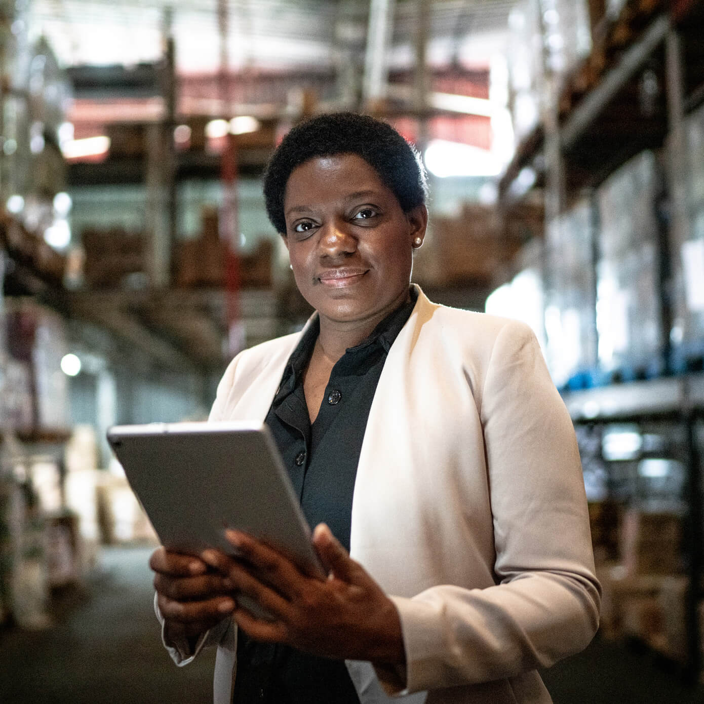 Supply-Chain-Leader-1459657302-1390x1390.jpg Image of a woman holding an electronic tablet.