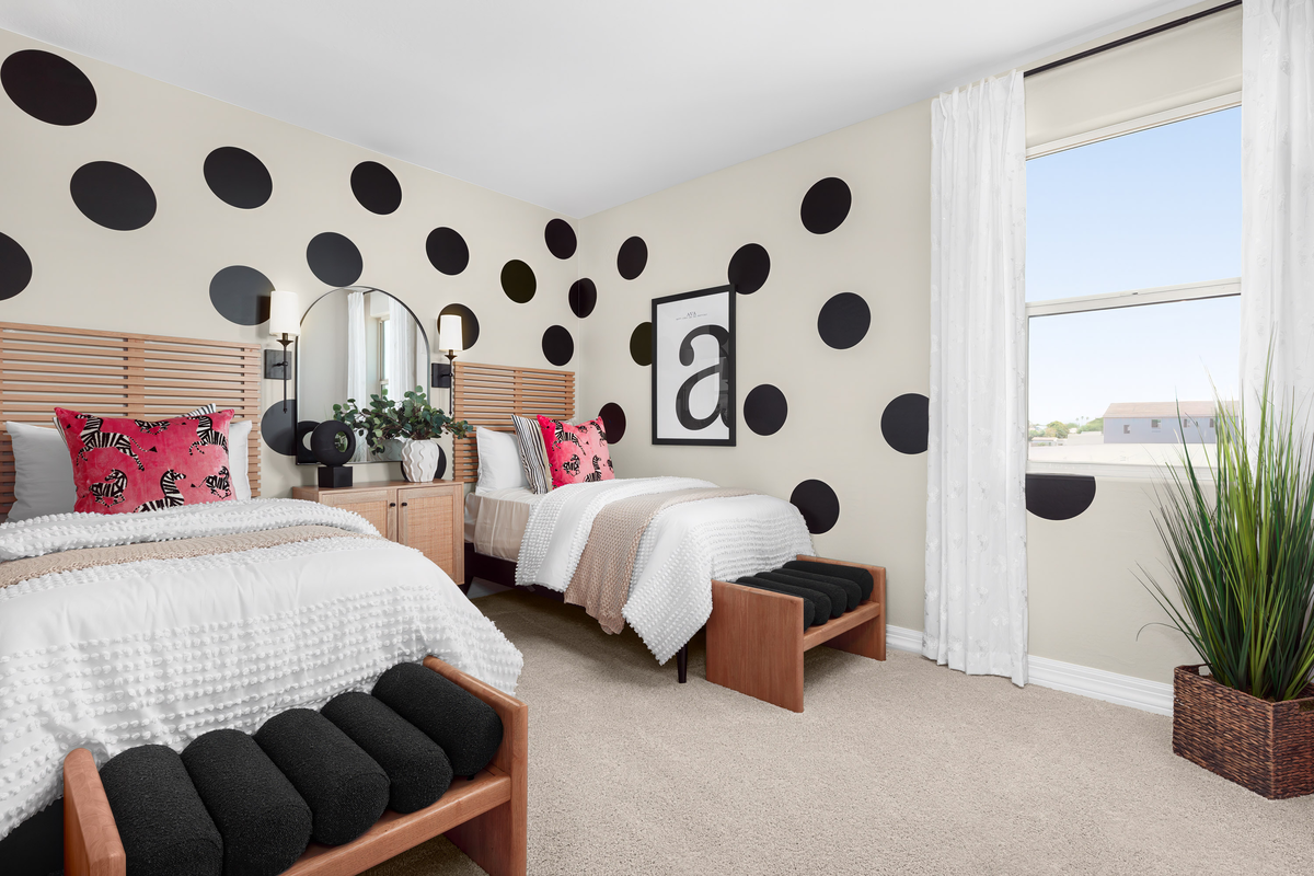 bedroom with two beds and wall art