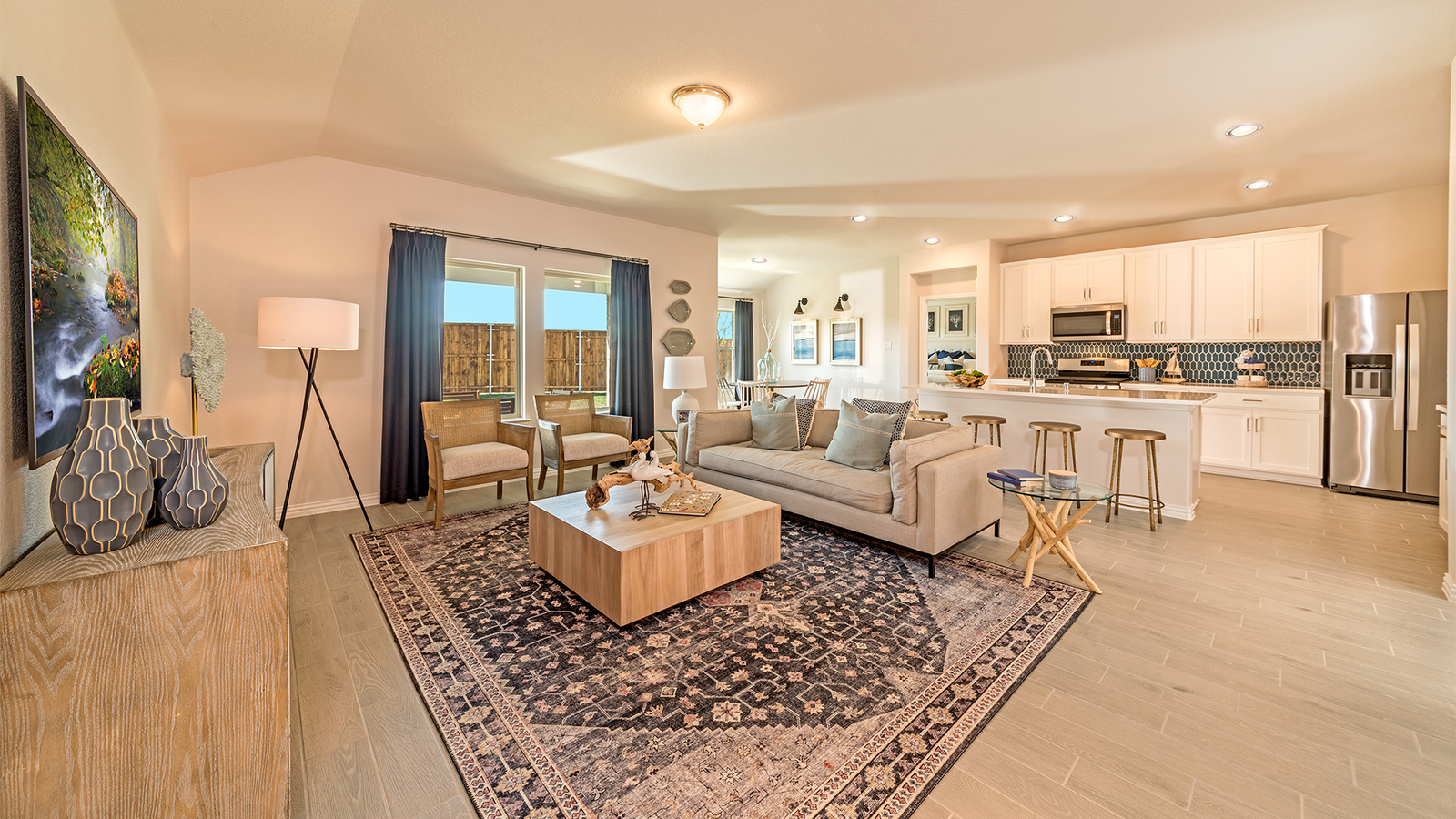 open great room with wood floors next to kitchen