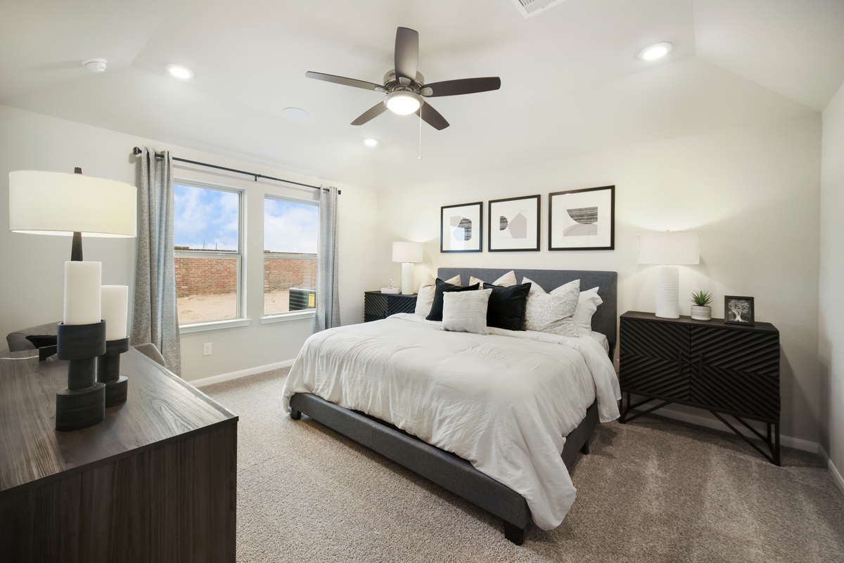 primary bedroom with wall art and nightstands