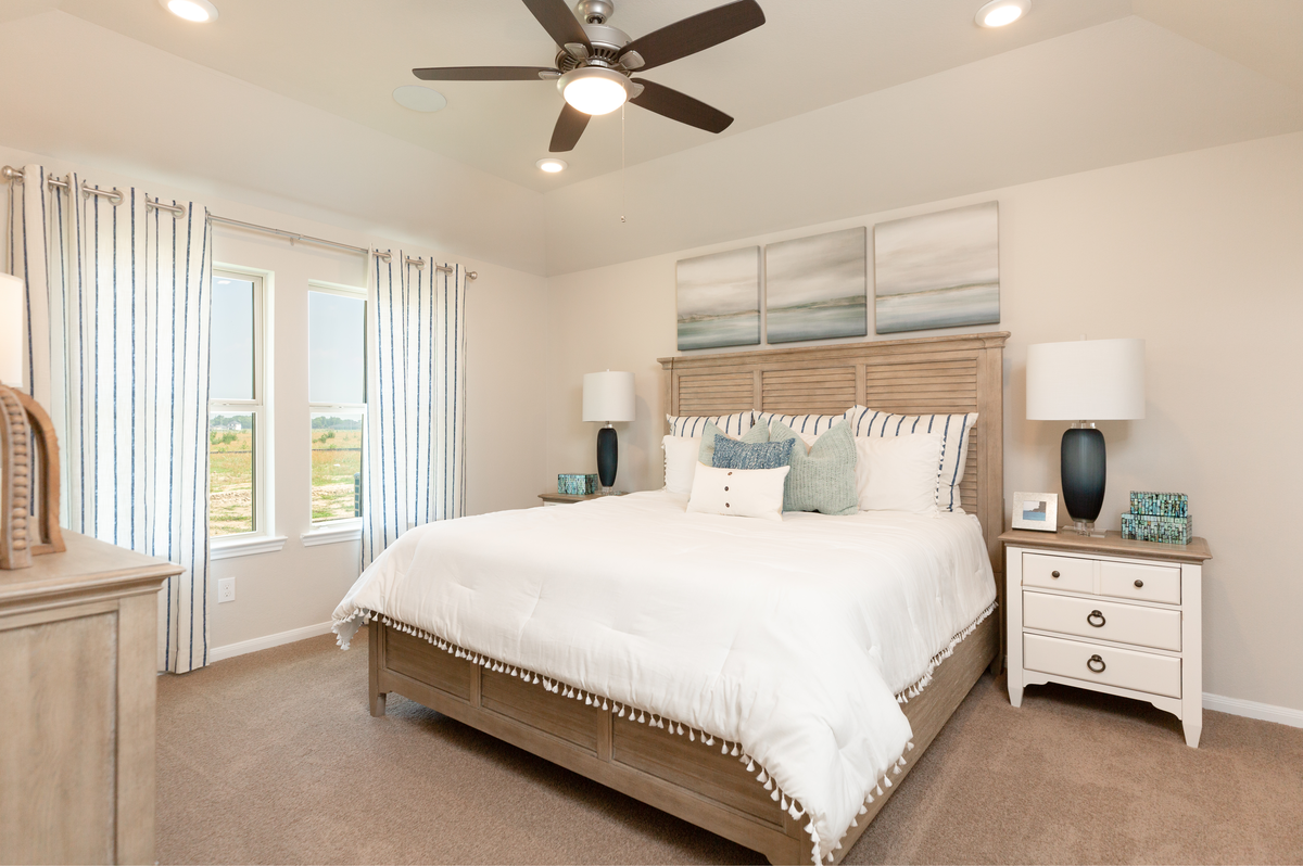 primary bedroom with ceiling fan and bed
