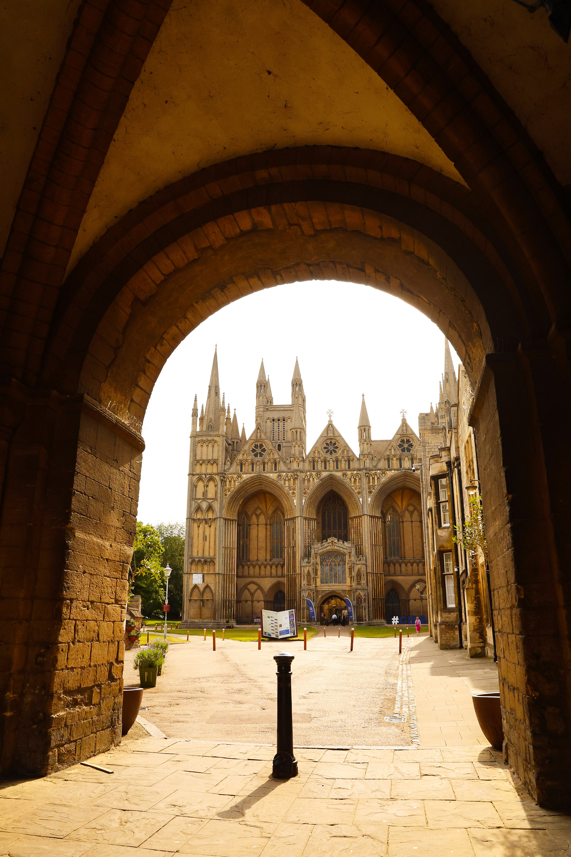 The cathedral exterior viewed through a dark stone archway