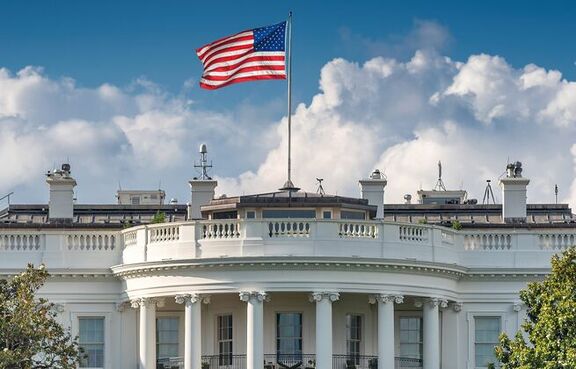 Front view of the White House with a U.S. waving on top of the building