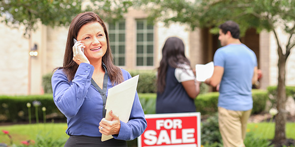 A real estate agent and a couple making an offer on a home