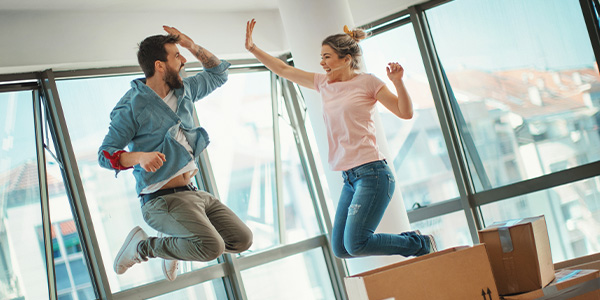 Young couple celebrating their new home purchase