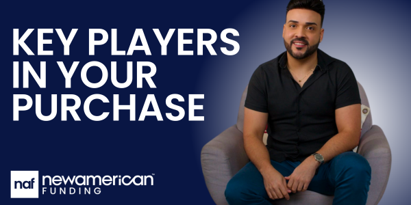 New American Funding Branch Manager Raulyer Hernandez sits on a chair smiling.