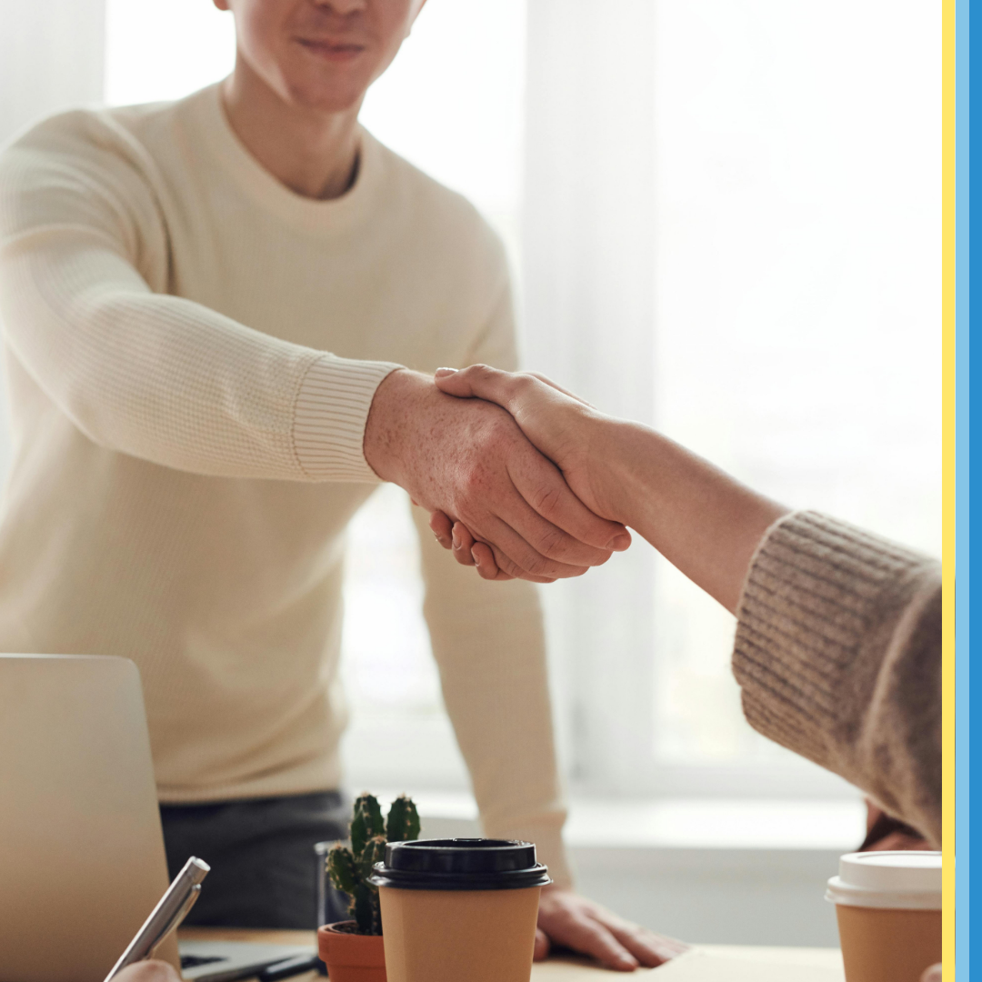 Man shaking hand with a job seeker after an interview.
