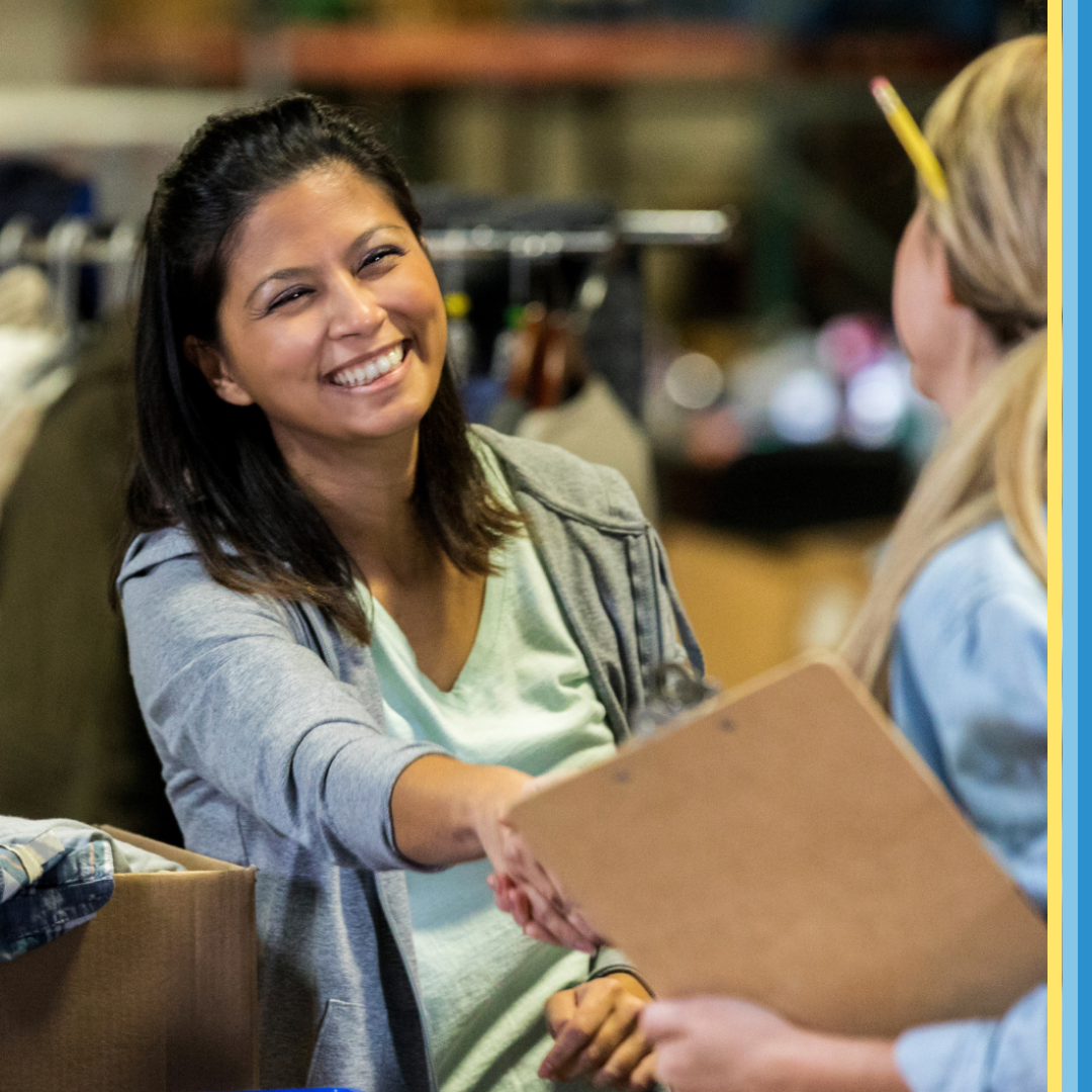 Women smiling and shaking hand with a shop assistant
