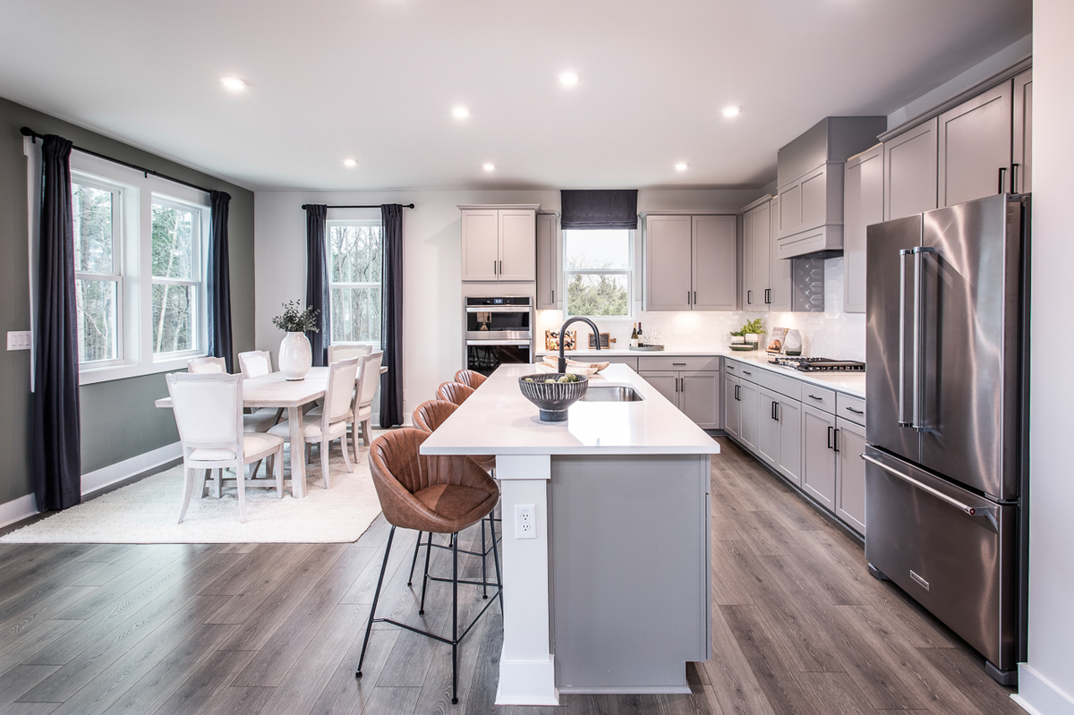 kitchen with gray cabinets open to breakfast room 