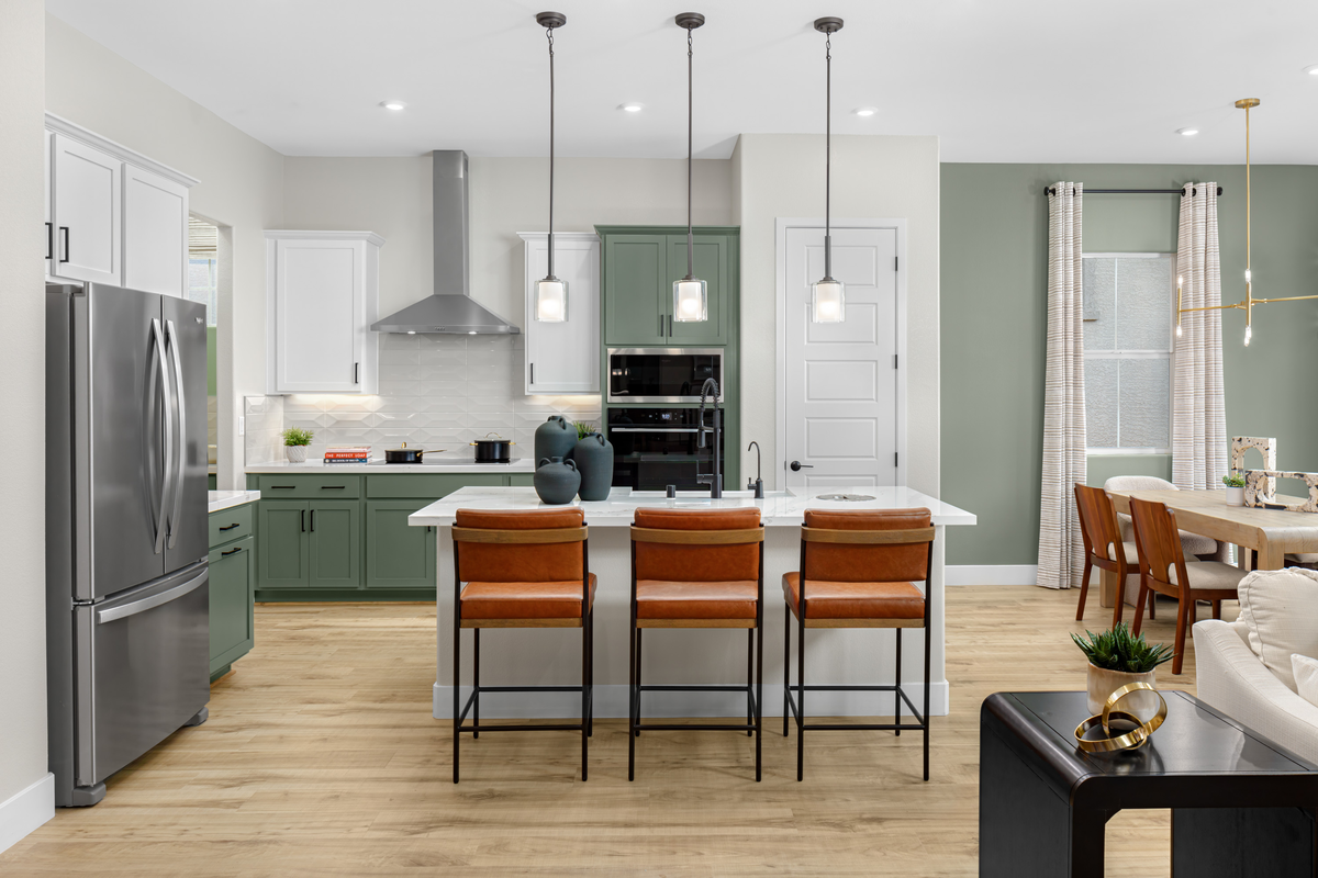 open and airy kitchen with green cabinets