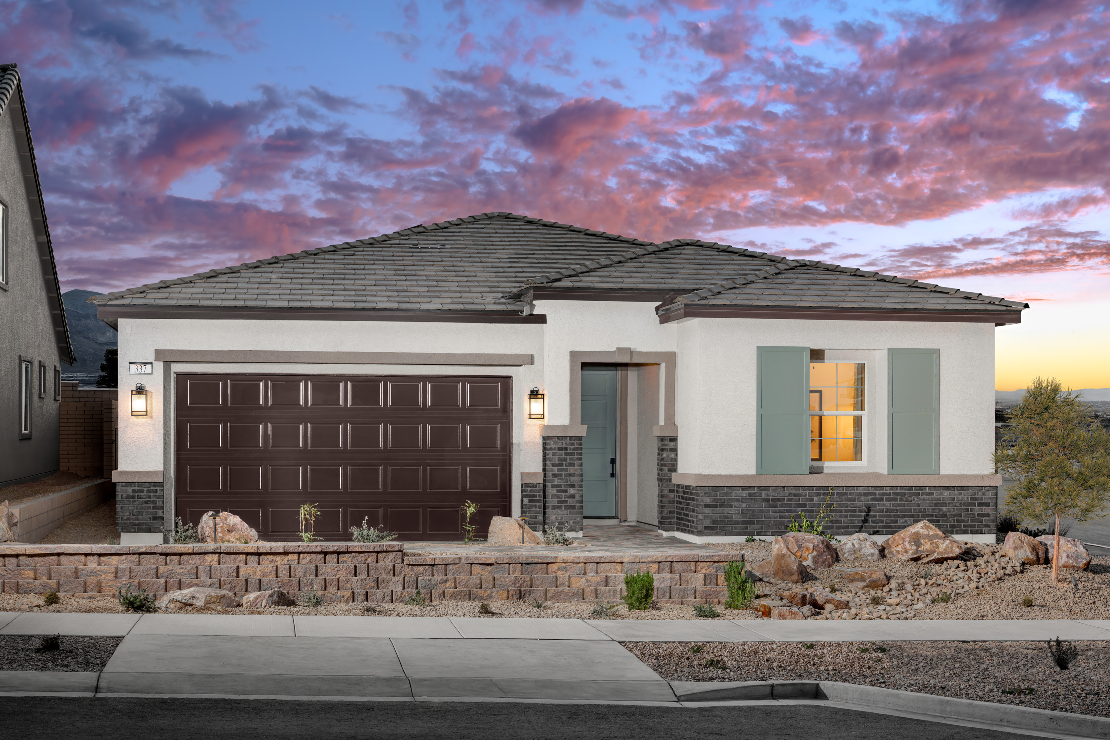 desert landscaping with brown two-car garage door
