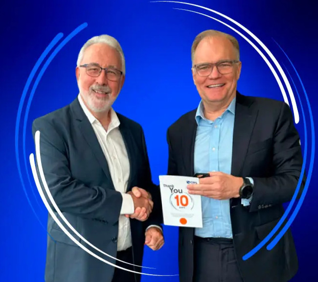 Ben Farrell, CIPS CEO, shaking hand with a volunteer, decorative circles in the background