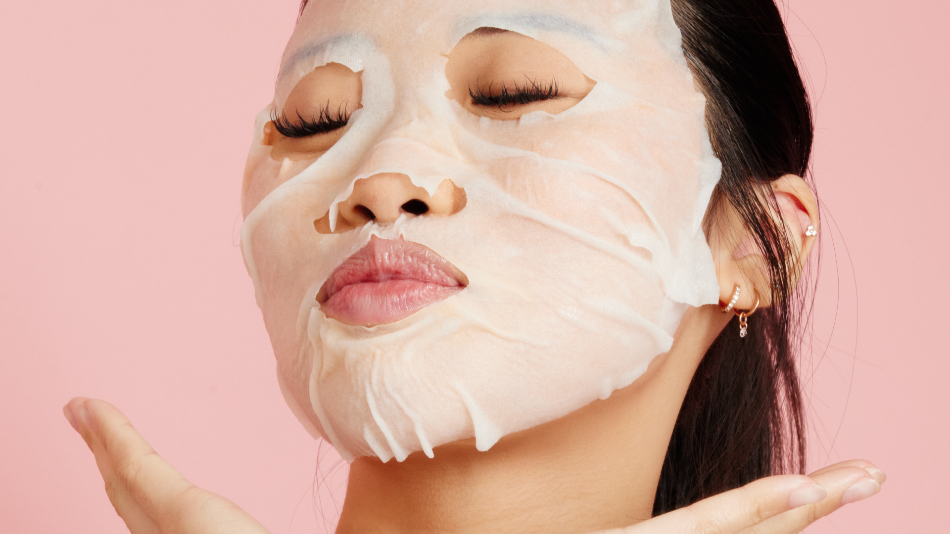 Girl holding a packet of Anti-Wrinkle Patches, and with small brown patches on her face