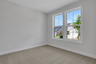 bedroom with windows and carpet