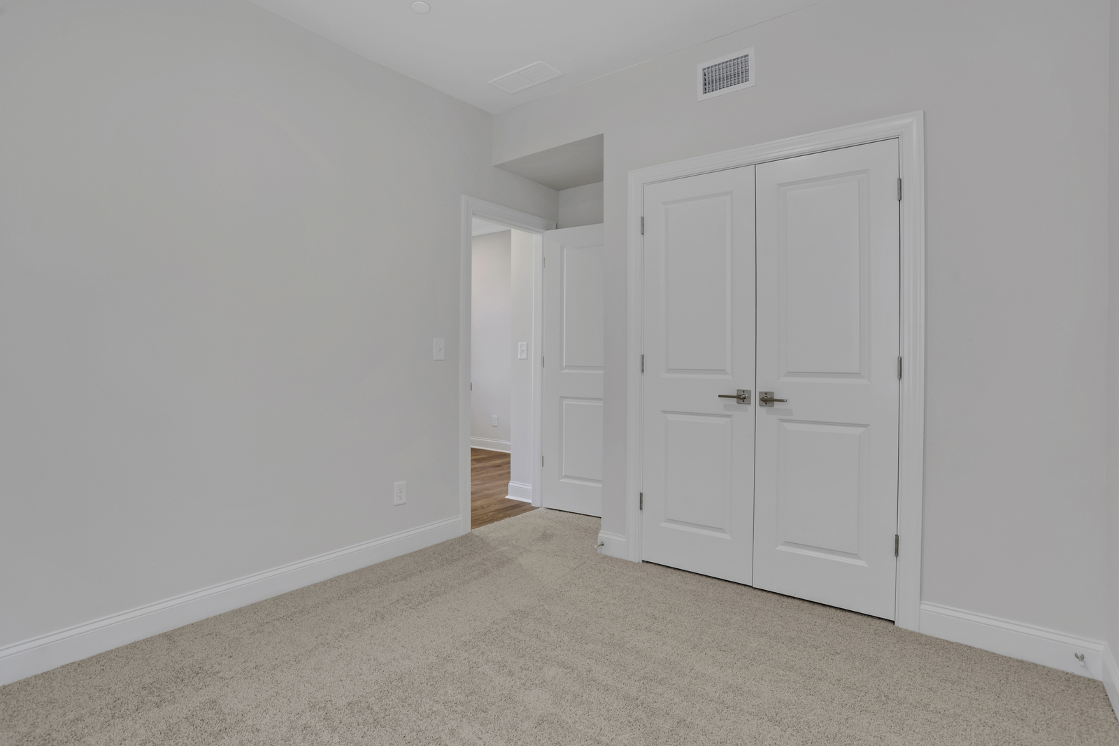 bedroom with windows and carpet