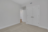 bedroom with windows and carpet