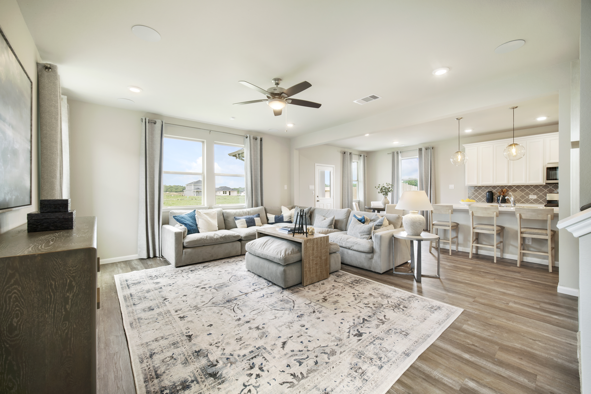 great room with ceiling fan