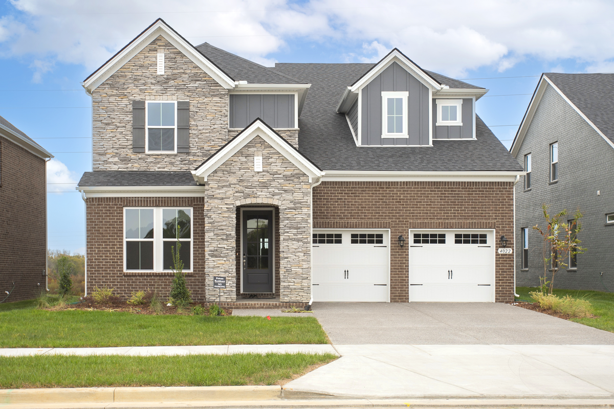 home exterior with brown brick and light stone