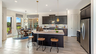 kitchen with black cabinets, white countertops, and a view of the breakfast area