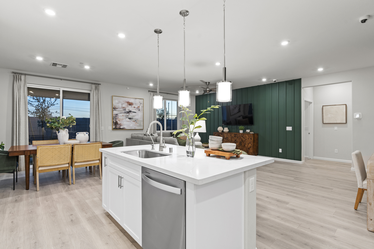great room with white countertops and accent wall