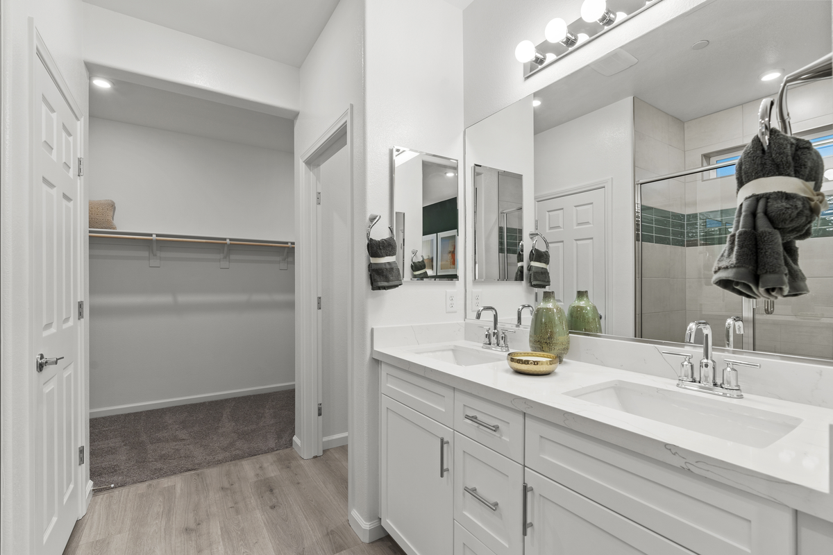 white countertops, cabinets, and walk-in closet
