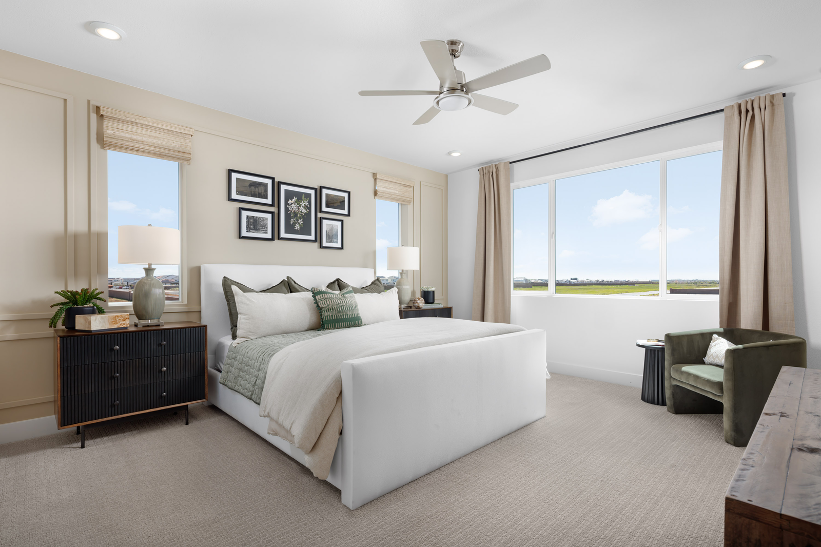 bedroom with tan carpet and white upholstered bed