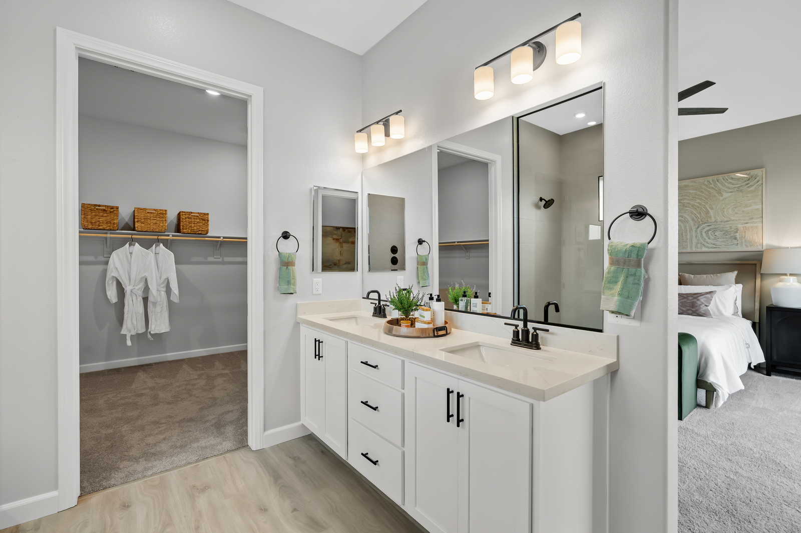primary bath with double sinks and walk-in closet