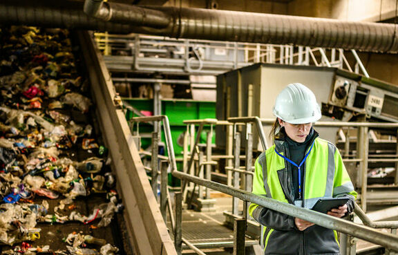 Worker monitoring waste processing in an industrial facility