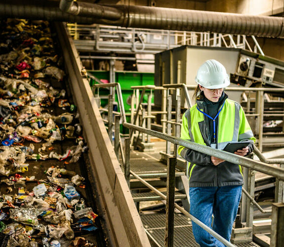 Worker monitoring waste processing in an industrial facility