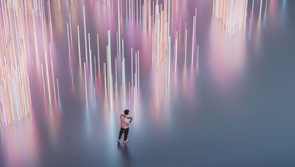 Man listening to music next to a light display