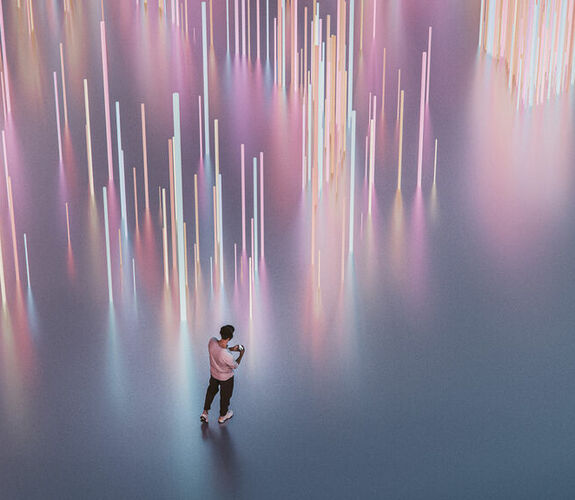 Man listening to music next to a light display