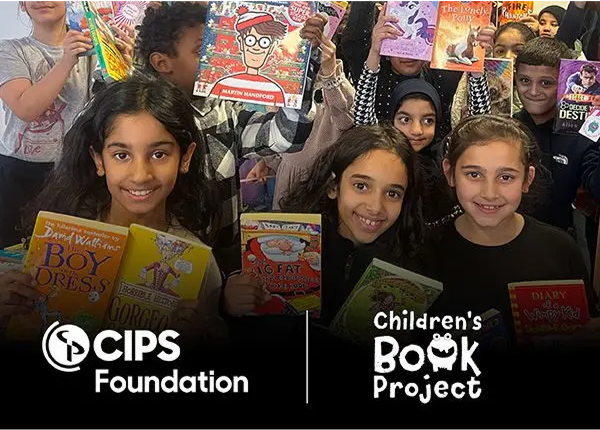 A group of smiling children holding up various children's books to the camera. The CIPS Foundation and Children's Book Project logos are shown at the bottom.